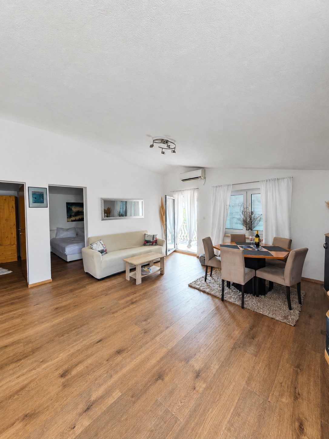 Bright living and dining room with wooden floor